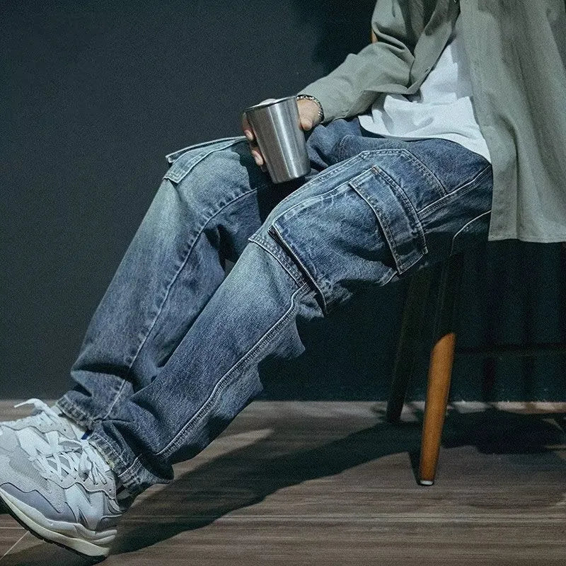 Blue men's loose straight-leg jeans with a zip fly on a neutral background.