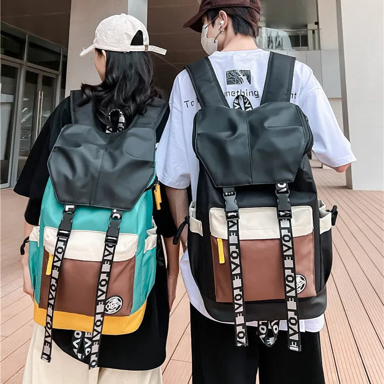 Oxford cloth backpack shown in black, green or red with handheld and shoulder straps.