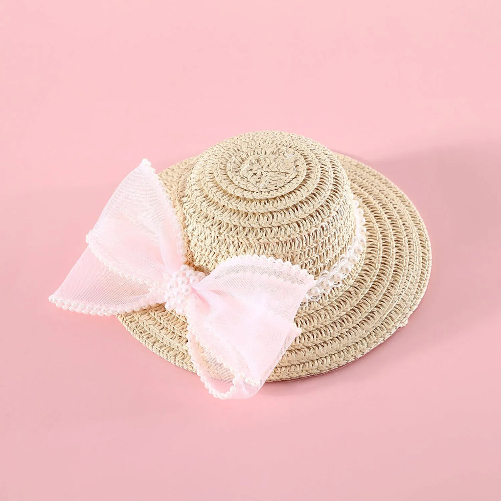 Pink pearl butterfly bow woven straw hat for a cat on a mannequin head.