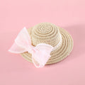 Pink pearl butterfly bow woven straw hat for a cat on a mannequin head.