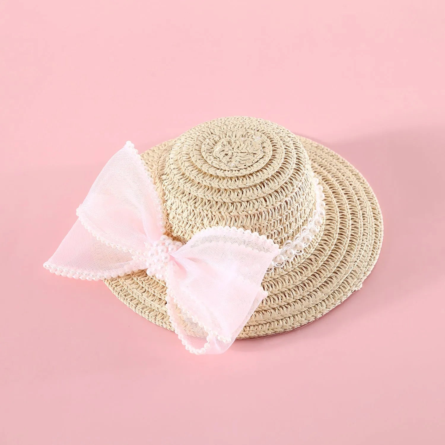 Pink pearl butterfly bow woven straw hat for a cat on a mannequin head.