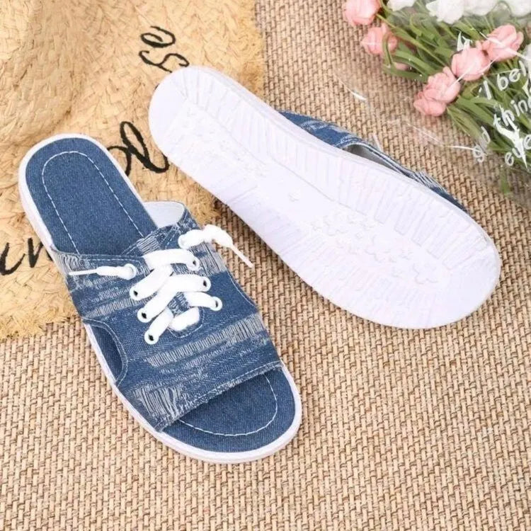 Blue Roman-style canvas slippers with flat rubber soles and cloth upper