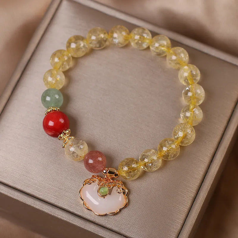 Women's bracelet with a yellow citrine jade ruyi pendant on an alloy chain.