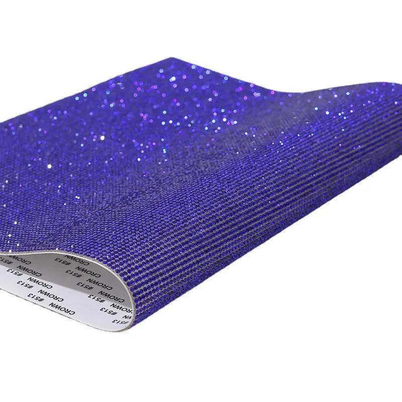 Sheet of rhinestones in an eight-eye pattern on a glue net backing, showing multiple colour options.