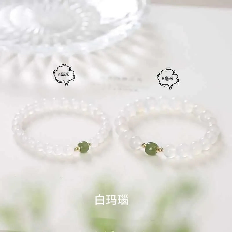 A handmade white agate style crystal bracelet with cinnabar inlay, shown in 6mm and 8mm bead sizes.