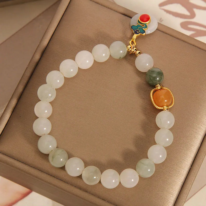 Women's ice jade bracelet with pearl accents and xiangyun peace jade buckle in retro design