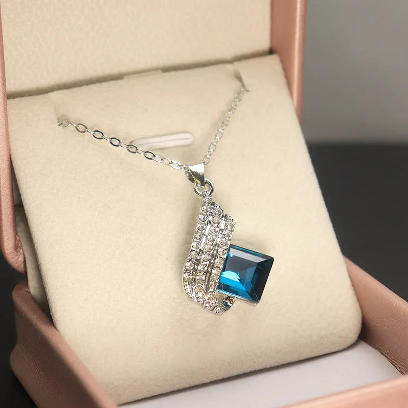 Women's necklace and earring set with a glass pendant on an electroplated alloy cross chain.