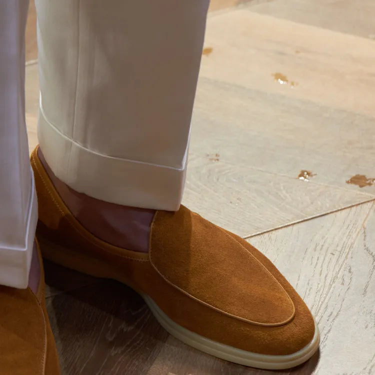 Men's brown genuine leather handmade loafers with a flexible TPR sole on a white background.