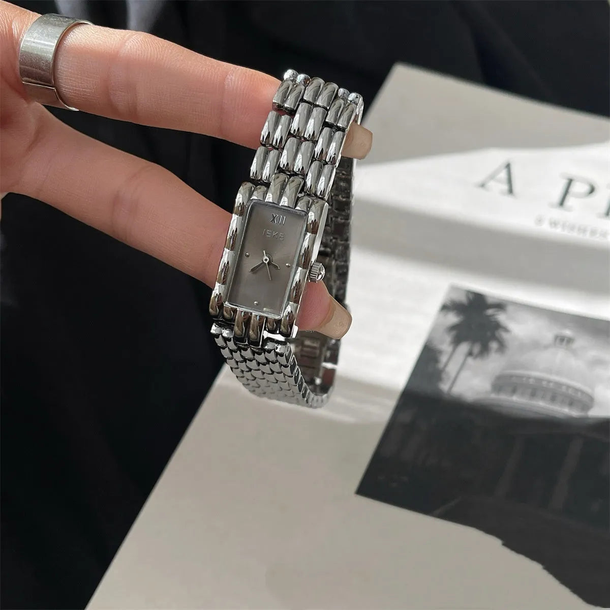 Women's silver and gold bracelet-style vintage watch with 15mm dial and butterfly clasp.