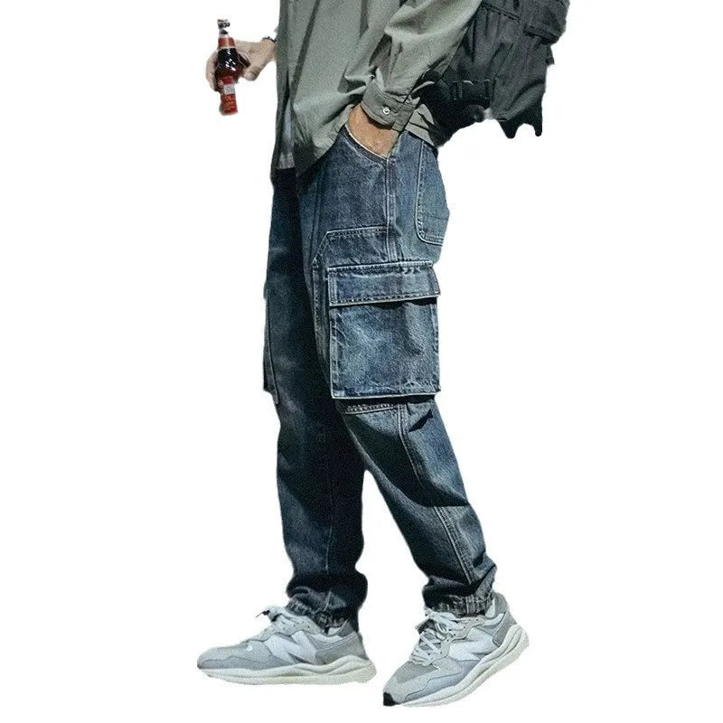 Blue men's loose straight-leg jeans with a zip fly on a neutral background.
