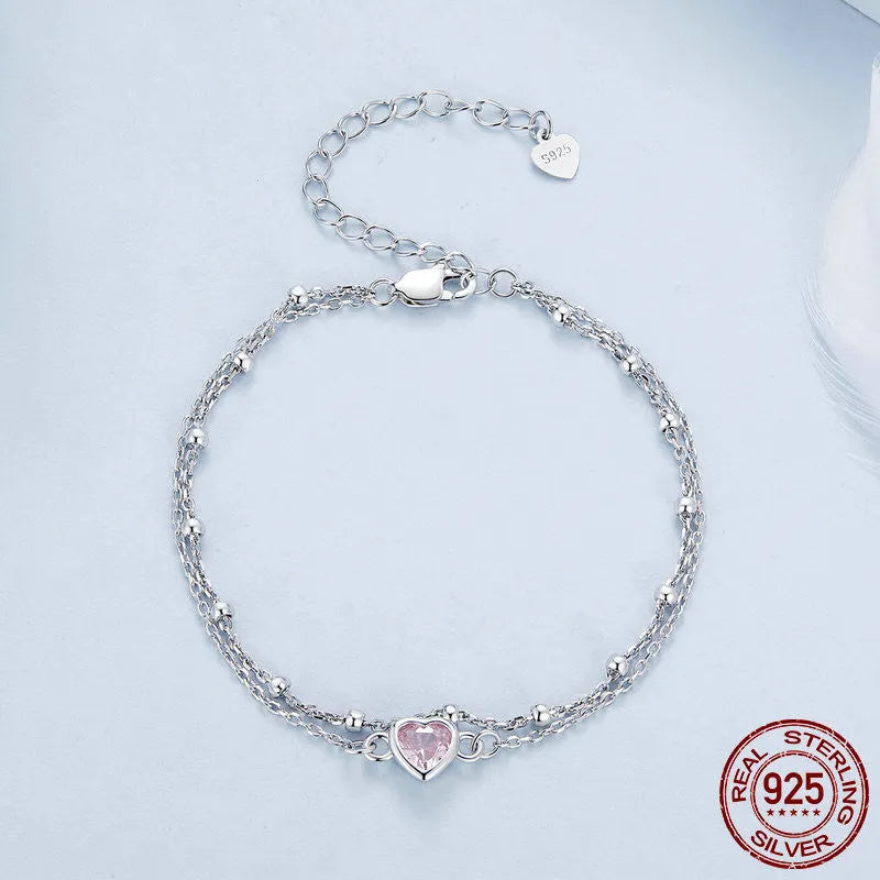 Women's sweet style sterling silver bracelet with a small heart-shaped charm on an adjustable chain.