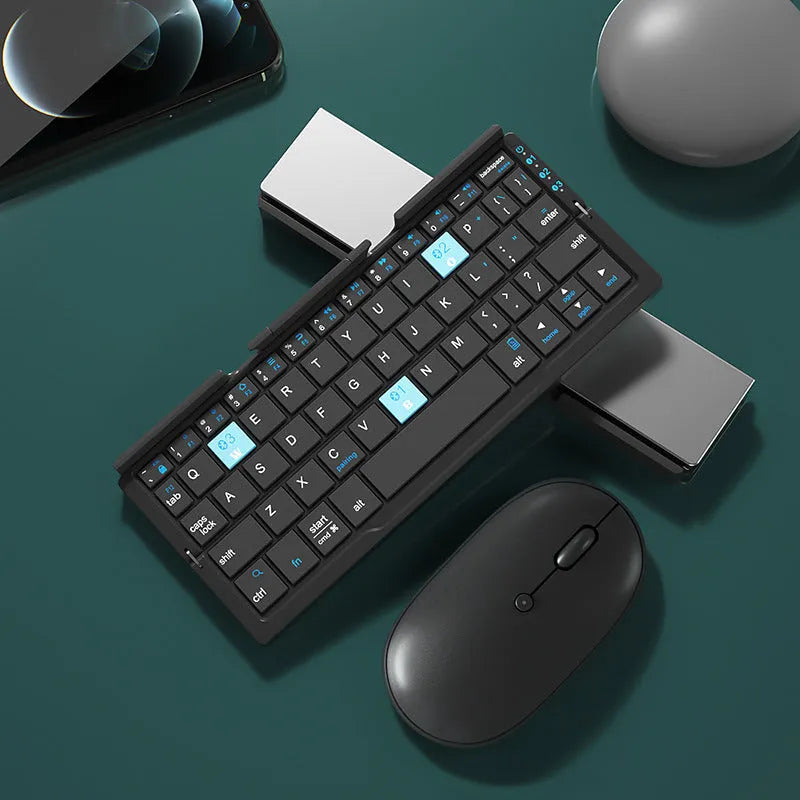 Silver white folding Bluetooth keyboard with stand holding a smartphone, showing compact folded size