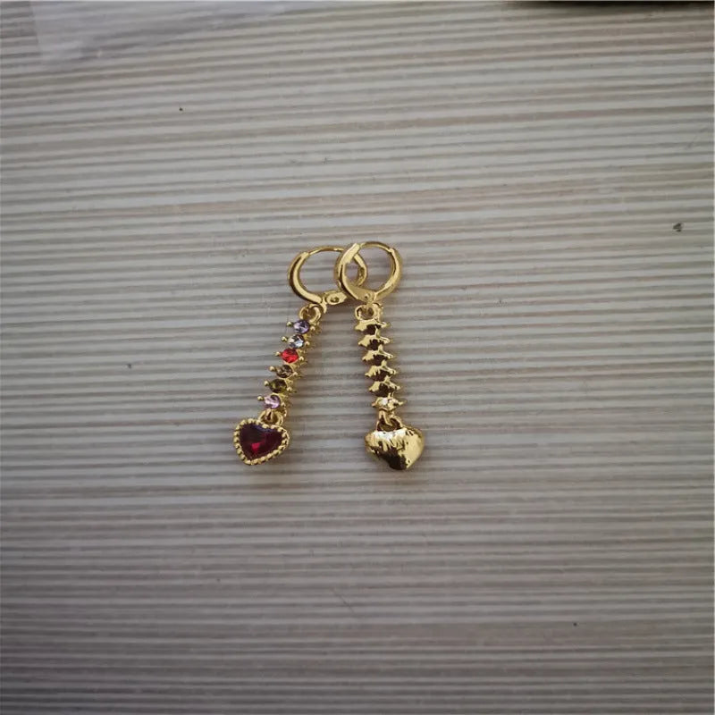 A pair of gold-coloured heart-shaped metal earrings for women.