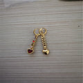 A pair of gold-coloured heart-shaped metal earrings for women.