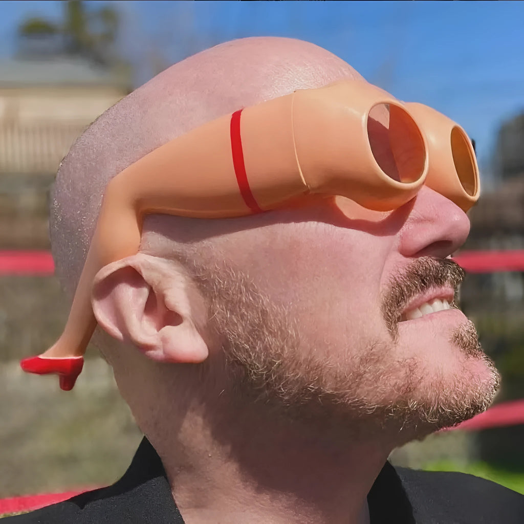 Orange oversized novelty plastic sunglasses for parties and travel.