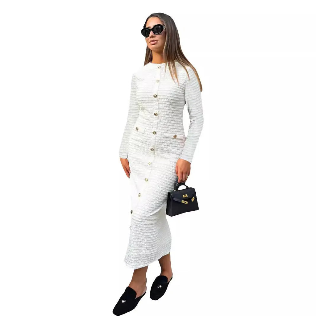A woman wearing a black French retro slim fit knitted long sleeve dress with button detail.