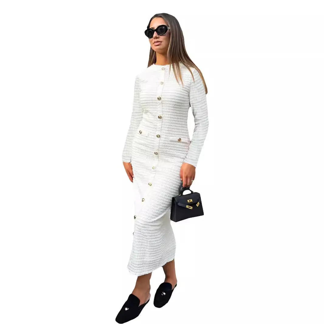 A woman wearing a black French retro slim fit knitted long sleeve dress with button detail.