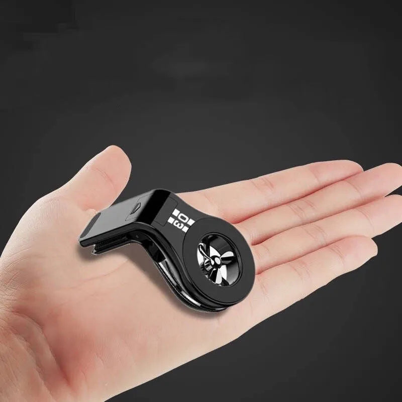 Black magnetic car phone holder attached to vehicle air vent with smartphone mounted