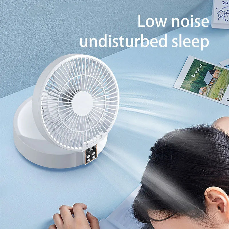 White portable rechargeable folding fan with night light and remote control on a desk
