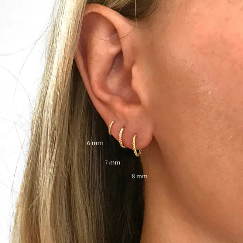 Sterling silver twisted round earrings in gold or white gold finish showing geometric design and S925 marking