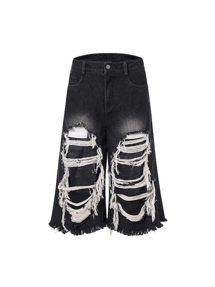 Black loose fit wide leg cropped jeans with a mid-high waist on a model.