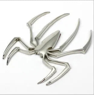 Three-dimensional metal spider bumper sticker in zinc alloy on a car bumper.