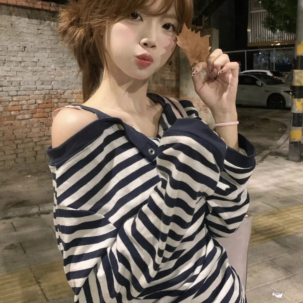 Dark blue Korean-style women's oversized long sleeve t-shirt with stripe and embroidery details on a hanger.