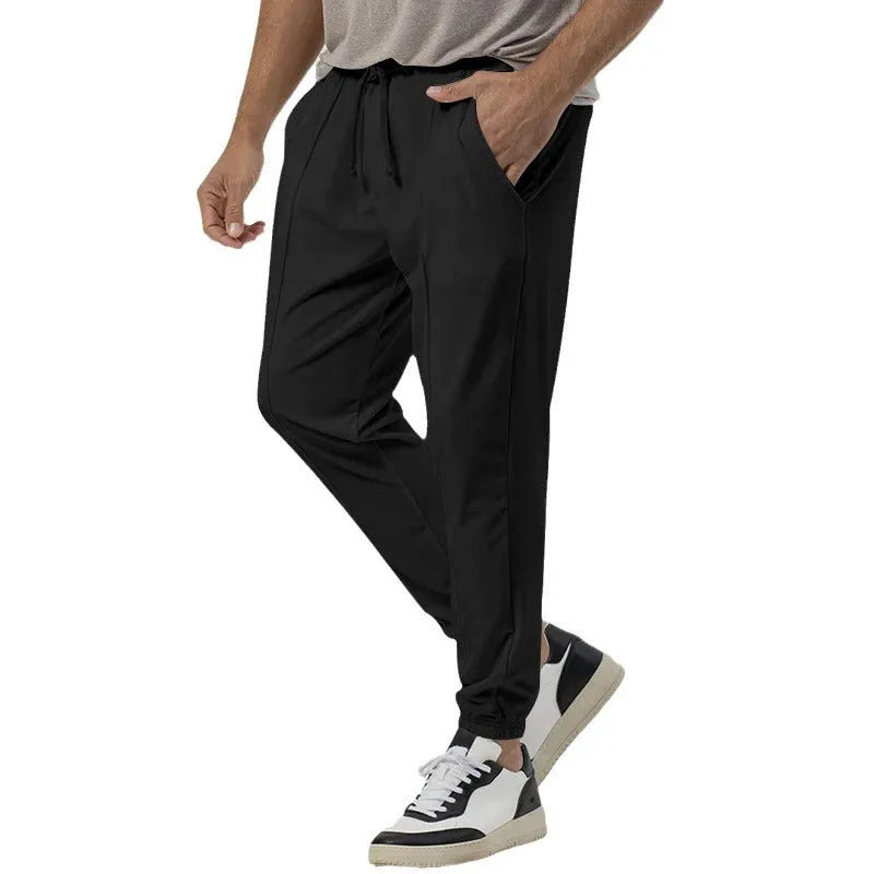 Men's grey straight-leg cotton blend sweatpants with an elasticated waistband on a white background.