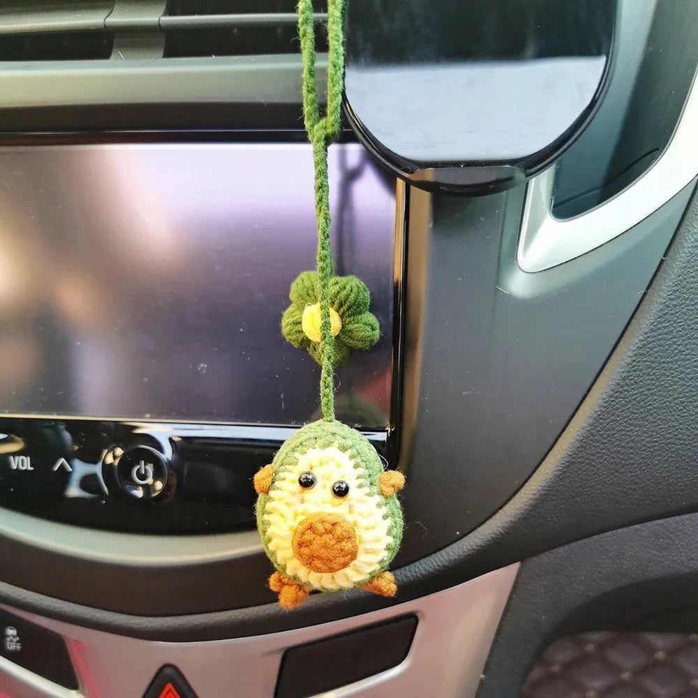 Handmade crocheted avocado-shaped and rainbow pattern car pendants made from wool yarn.