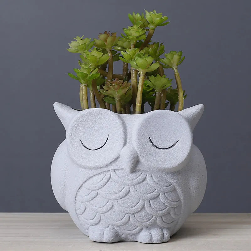 Handmade frosted ceramic succulent pot with cartoon owl design, shown in light pink.