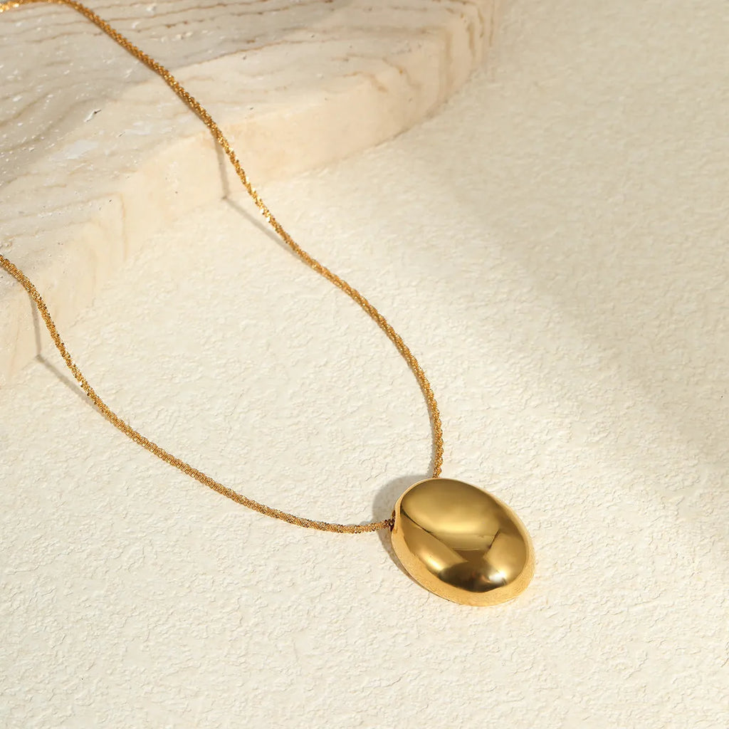 Geometric gold pendant on adjustable stainless steel chain necklace with regular links