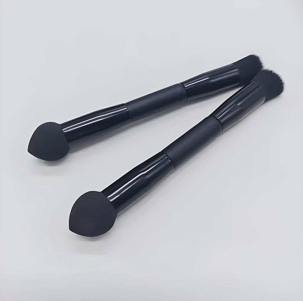Double-headed concealer brush with tapered bristles and a miter sponge on a long black wooden handle.