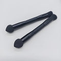 Double-headed concealer brush with tapered bristles and a miter sponge on a long black wooden handle.