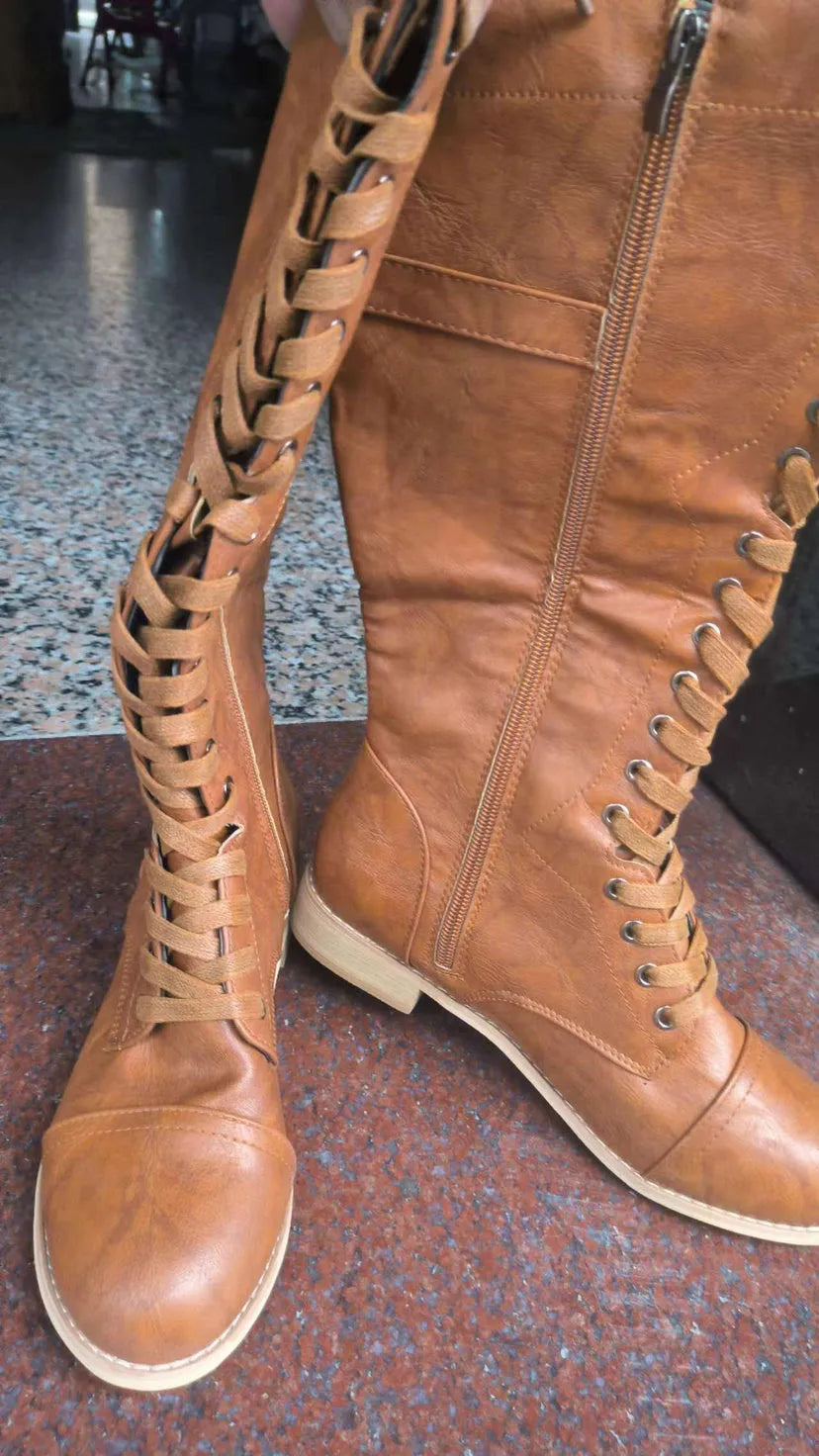 Women's black cross strap knight boots with side buckle fastening on artificial PU upper
