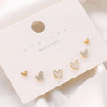 Three pairs of heart-shaped alloy earrings with electroplated finishes in gold, black, black-white, and pink colours