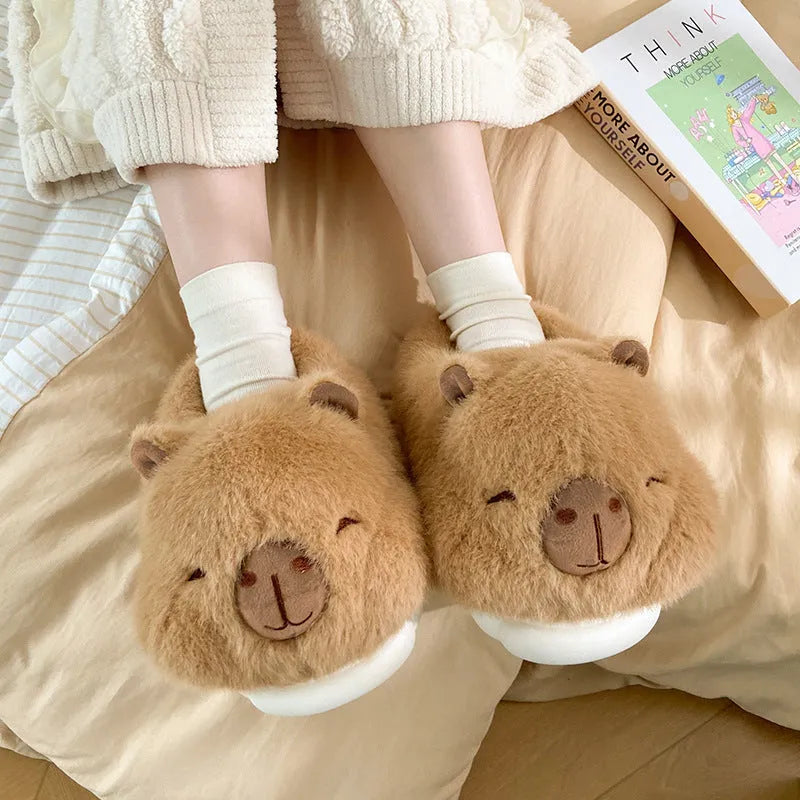 Light brown women's winter slippers with a cartoon pattern, plush upper, and round toe.