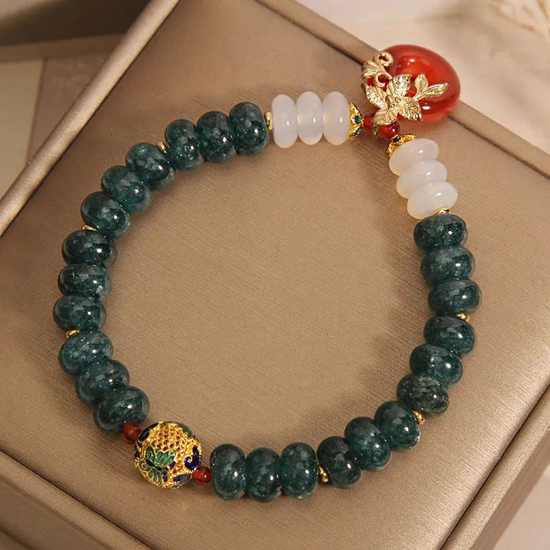 Women's blue water jade and red agate crystal bracelet with peace buckle closure