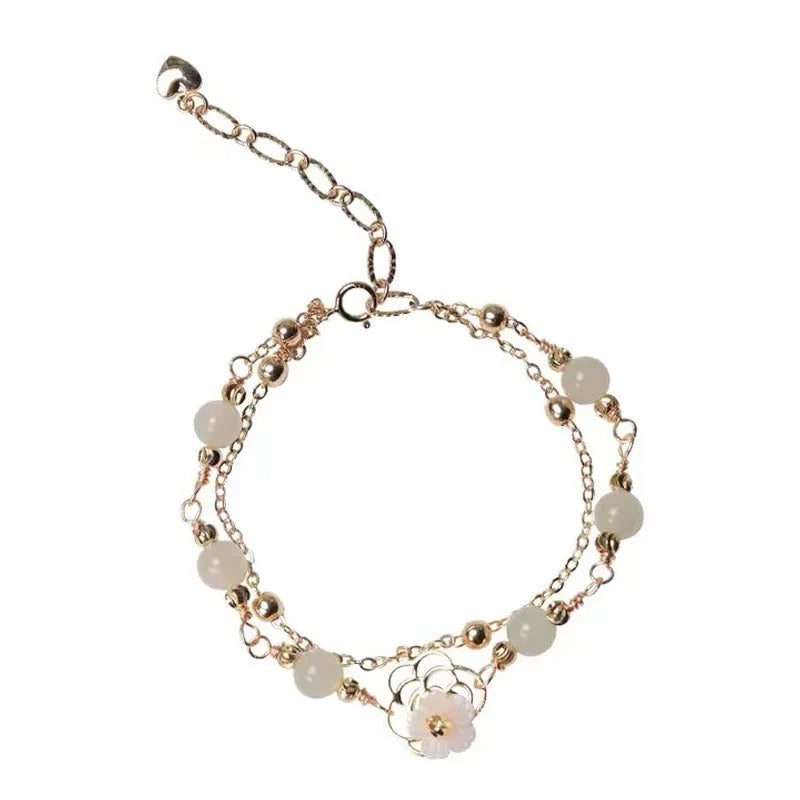 Yellow gold electroplated copper bracelet with genuine Hetian jade Bells of Ireland butterfly charm for women.