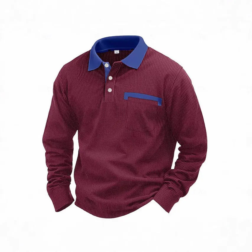 Man wearing a long-sleeved waffle-textured polo shirt in a dark colour with an asymmetric design detail.