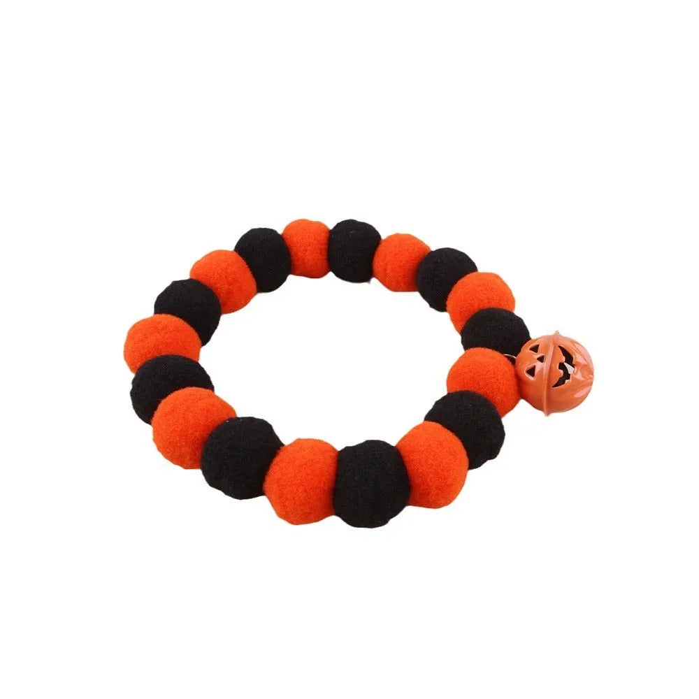 Orange and black pumpkin-themed adjustable cat collar for Halloween costumes.