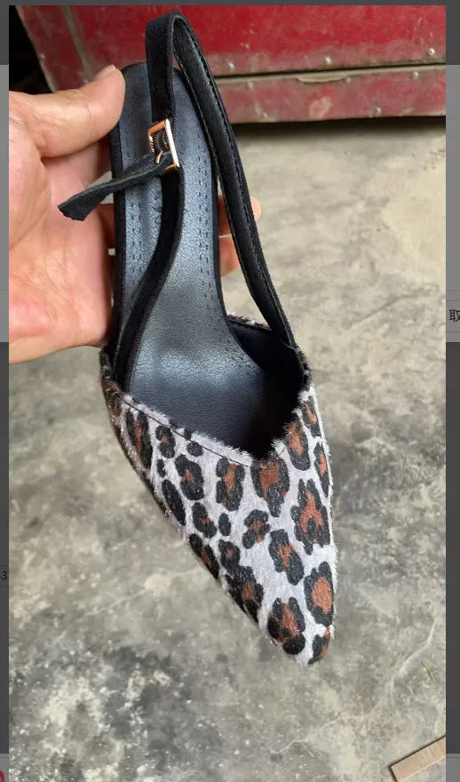 Women's leopard print suede sandals with a pointed toe on a white background.