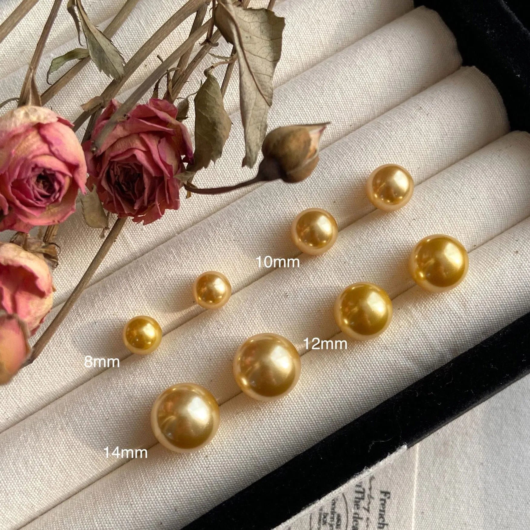 Large pearl stud earrings with geometric silver settings and eight-pointed star details