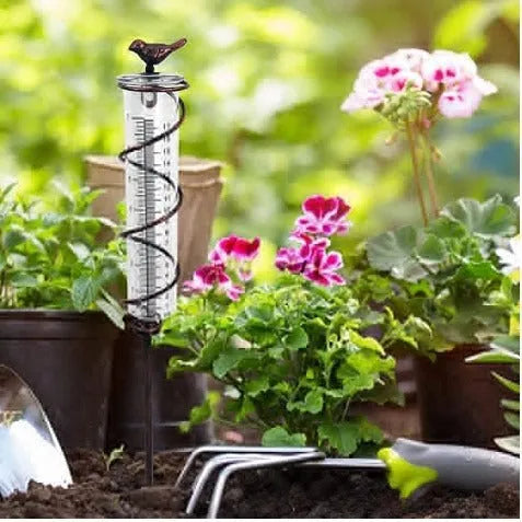 Cast iron garden rain gauge with hummingbird decoration showing 1-20 scale markings