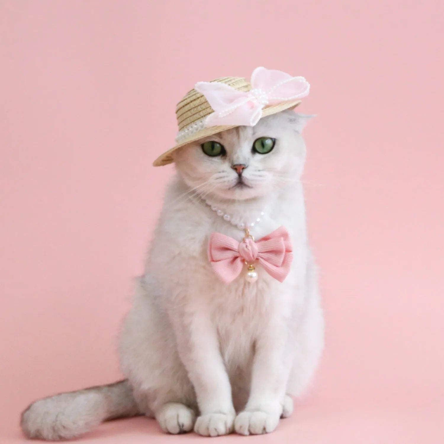 Pink pearl butterfly bow woven straw hat for a cat on a mannequin head.