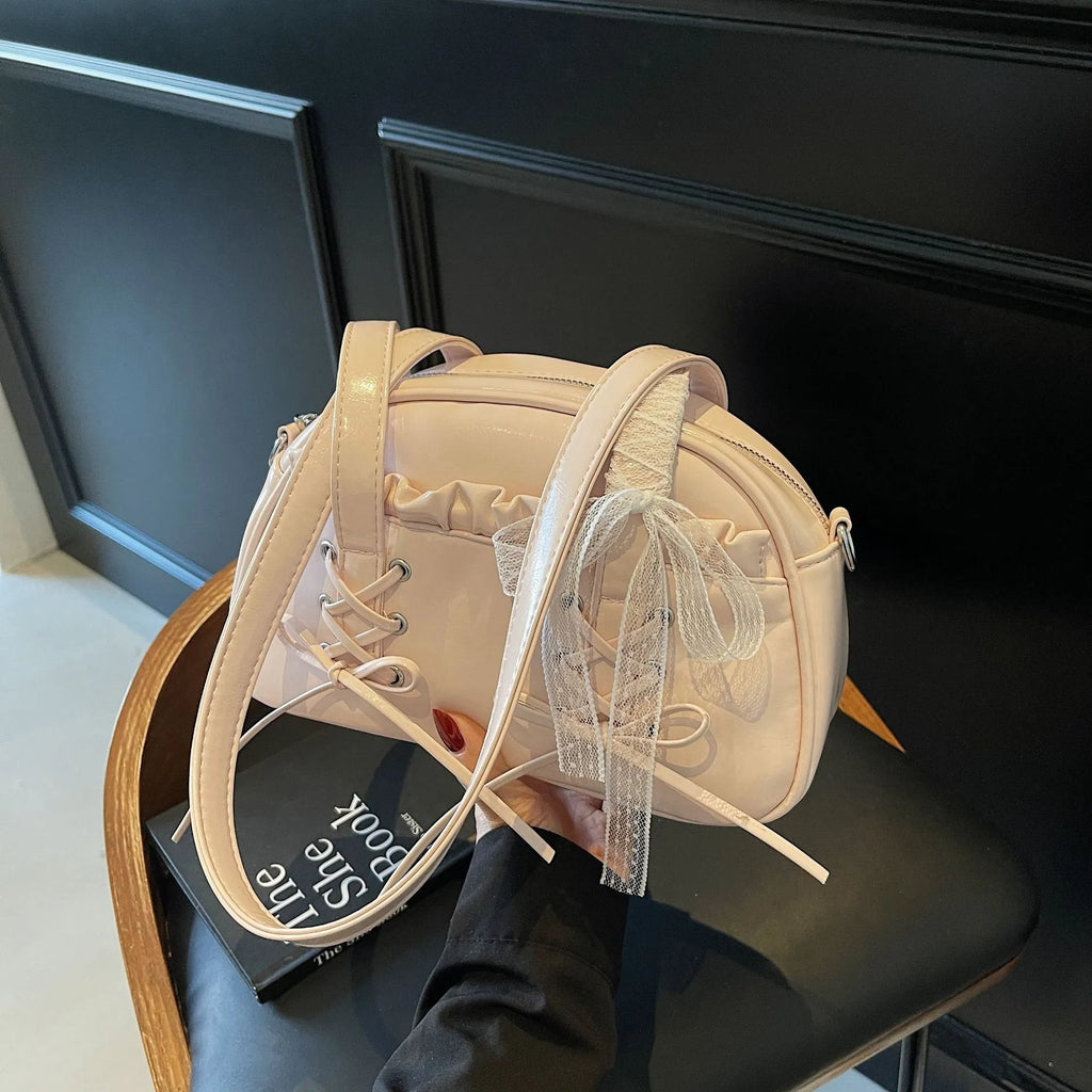 Women's casual shoulder handbag with bandage bow detail in PU material showing internal phone compartment