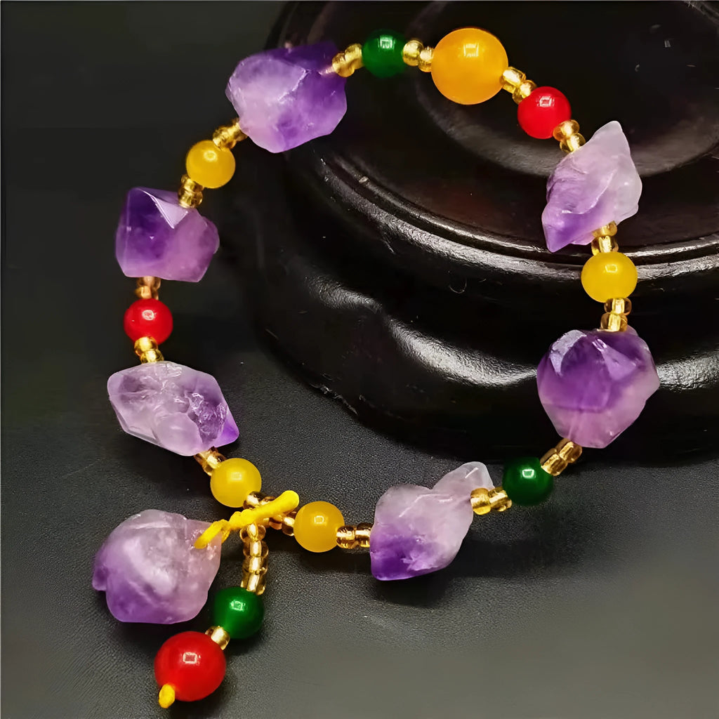 Natural purple amethyst bead bracelet for women with a fu character charm on a white background.