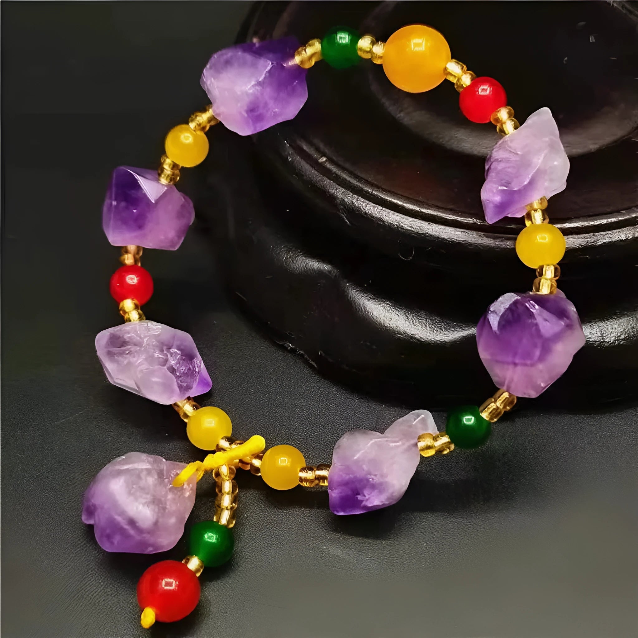 Natural purple amethyst bead bracelet for women with a fu character charm on a white background.