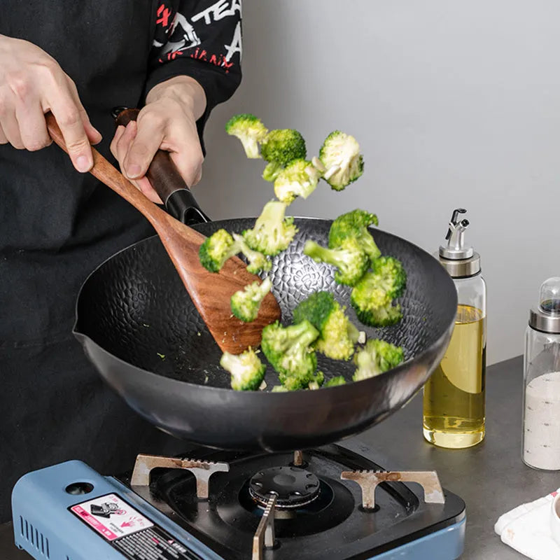 Traditional black iron wok pan with wooden handle measuring 32cm diameter