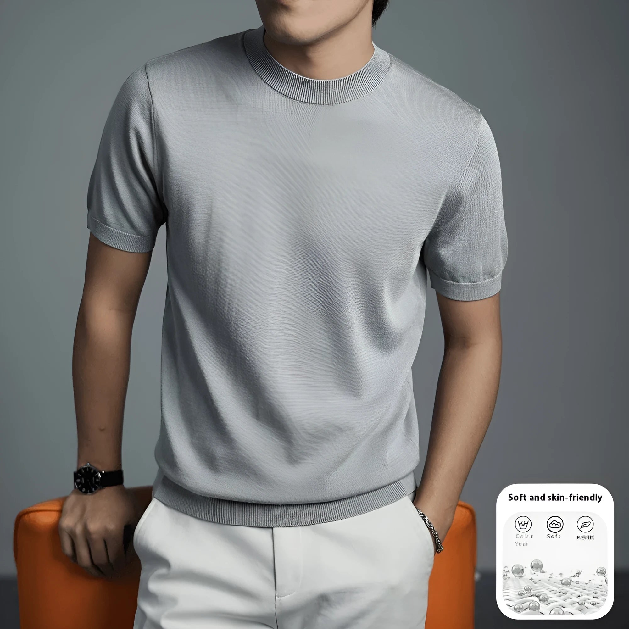 Man wearing a solid colour knitted t-shirt with round neck and short sleeves, showcasing business casual style.