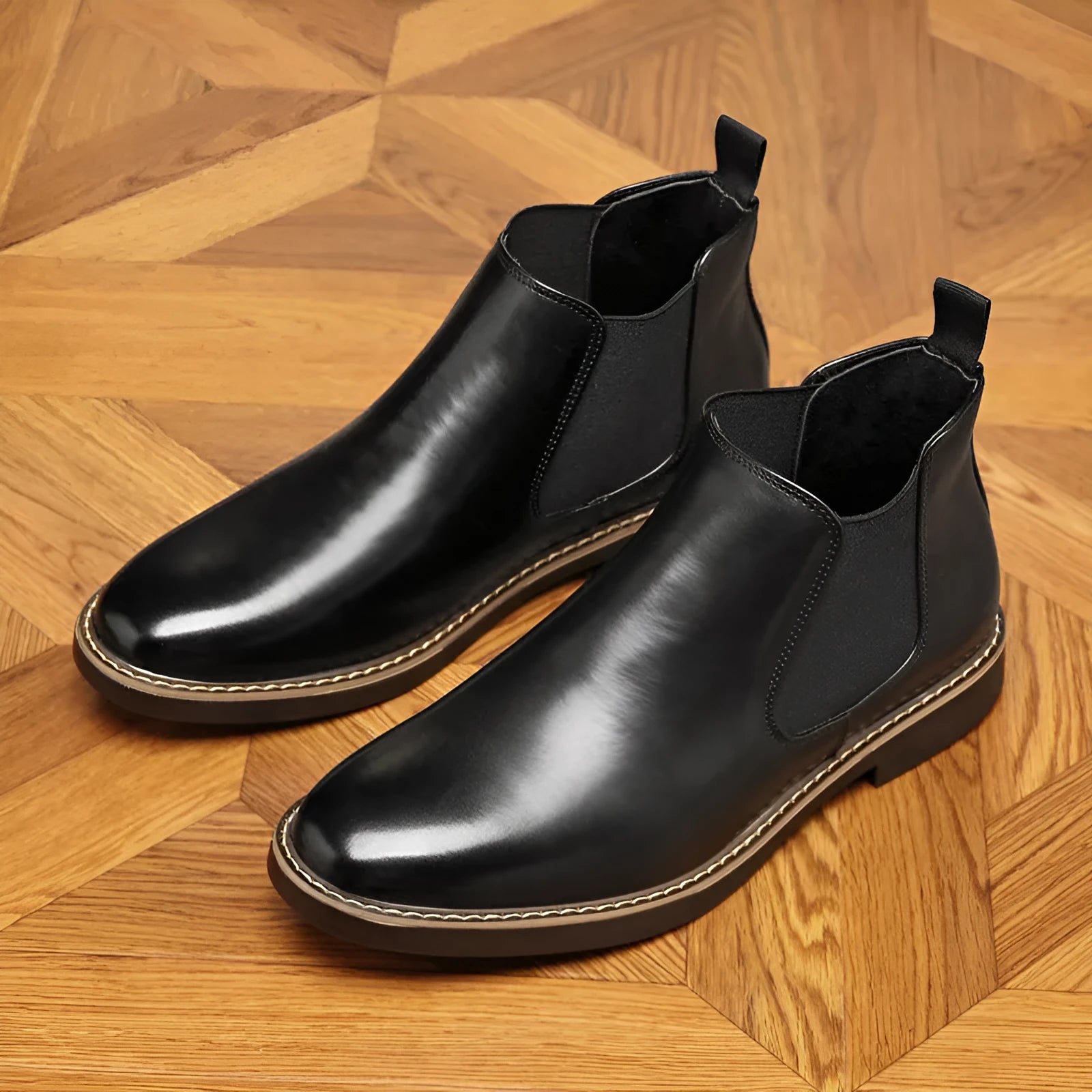 A pair of black formal pointed-toe leather boots with a square heel and rubber sole.